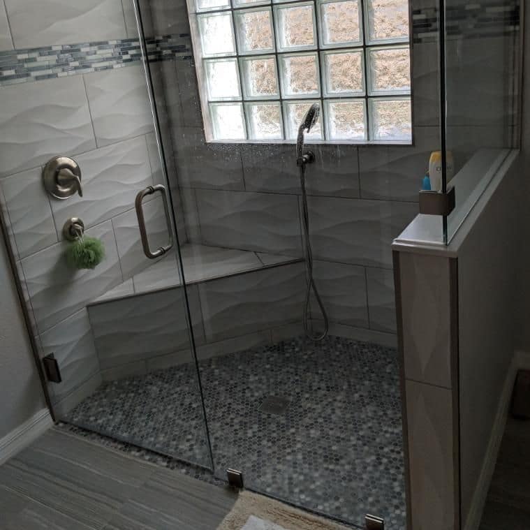 Tiled walk-in shower with a glass enclosure