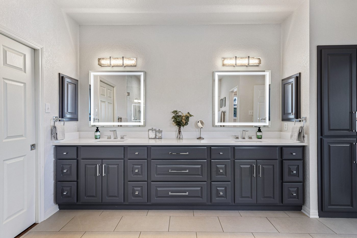 Bathroom remodel with navy double vanity and framed mirrors