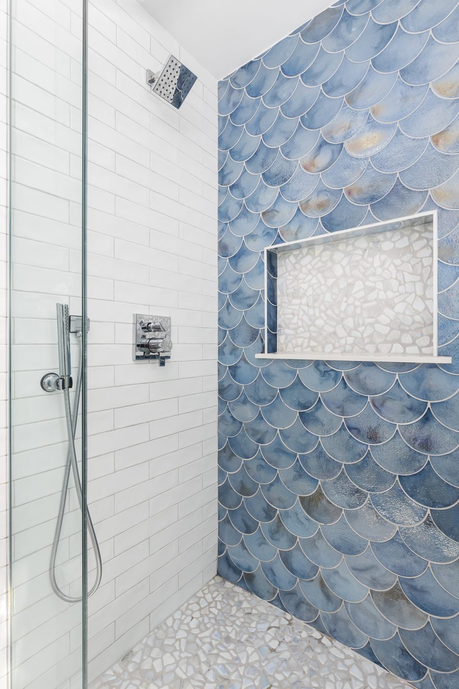 Walk-in shower with blue scalloped accent tile