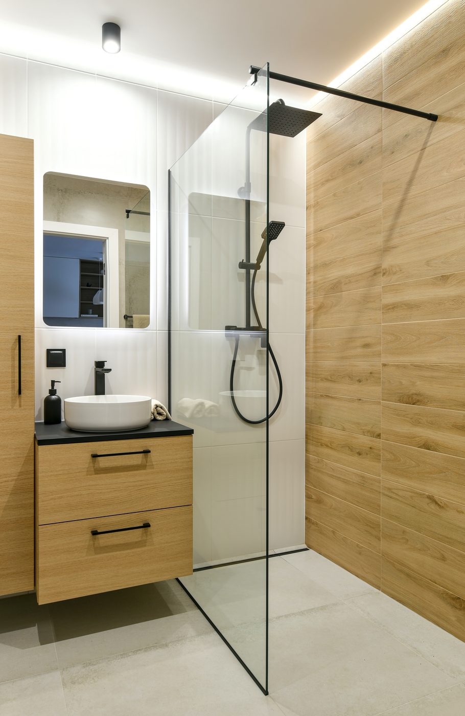 Modern walk-in shower with wood accent wall